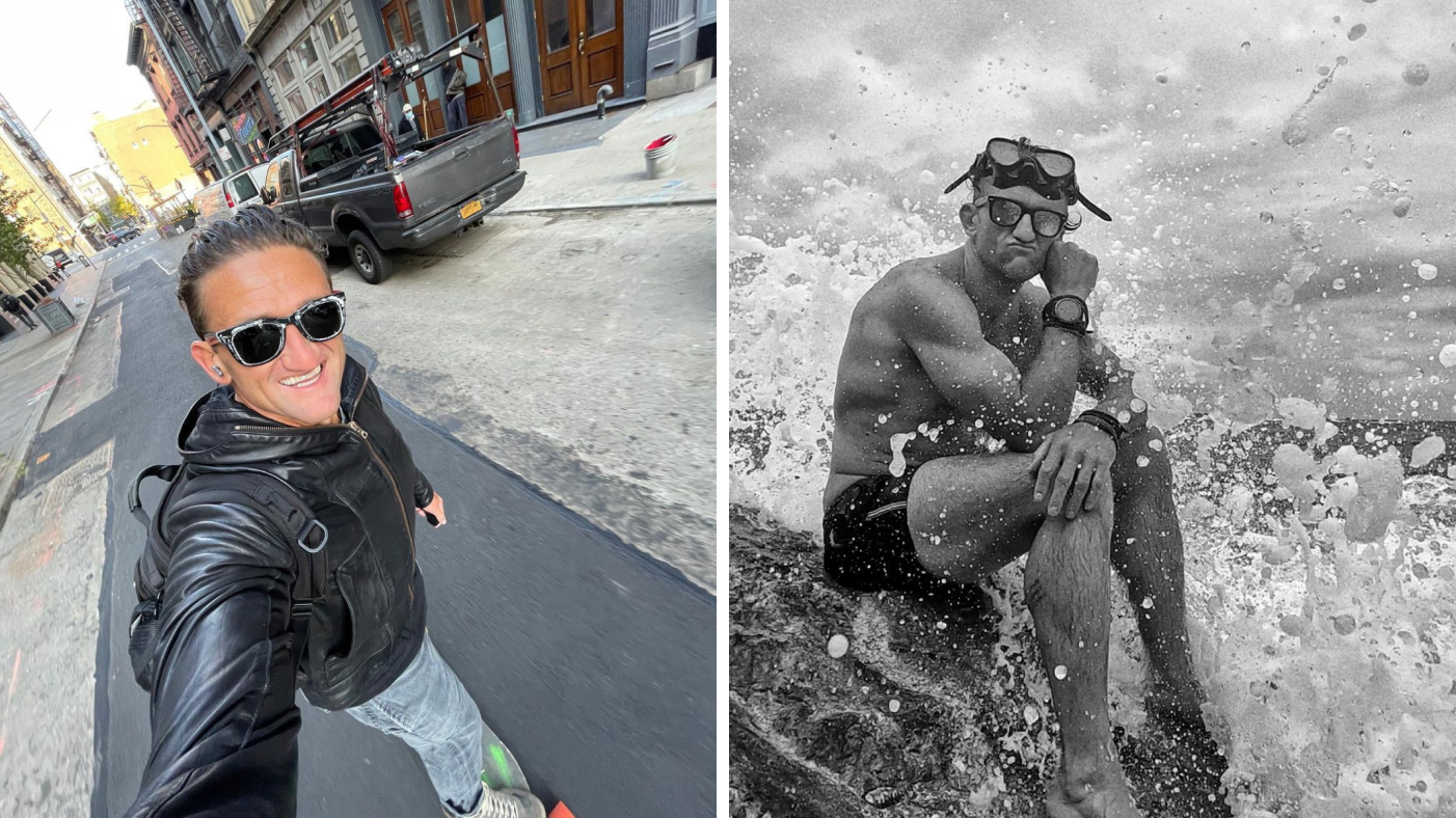 Casey Neistat riding a skate and sitting on a rock at the sea coast