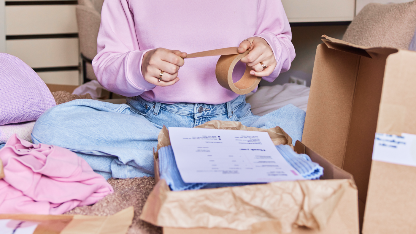 Girl packing product with a bill in a box