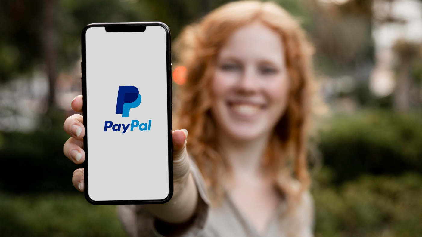 Girl showing PayPal app on her phone