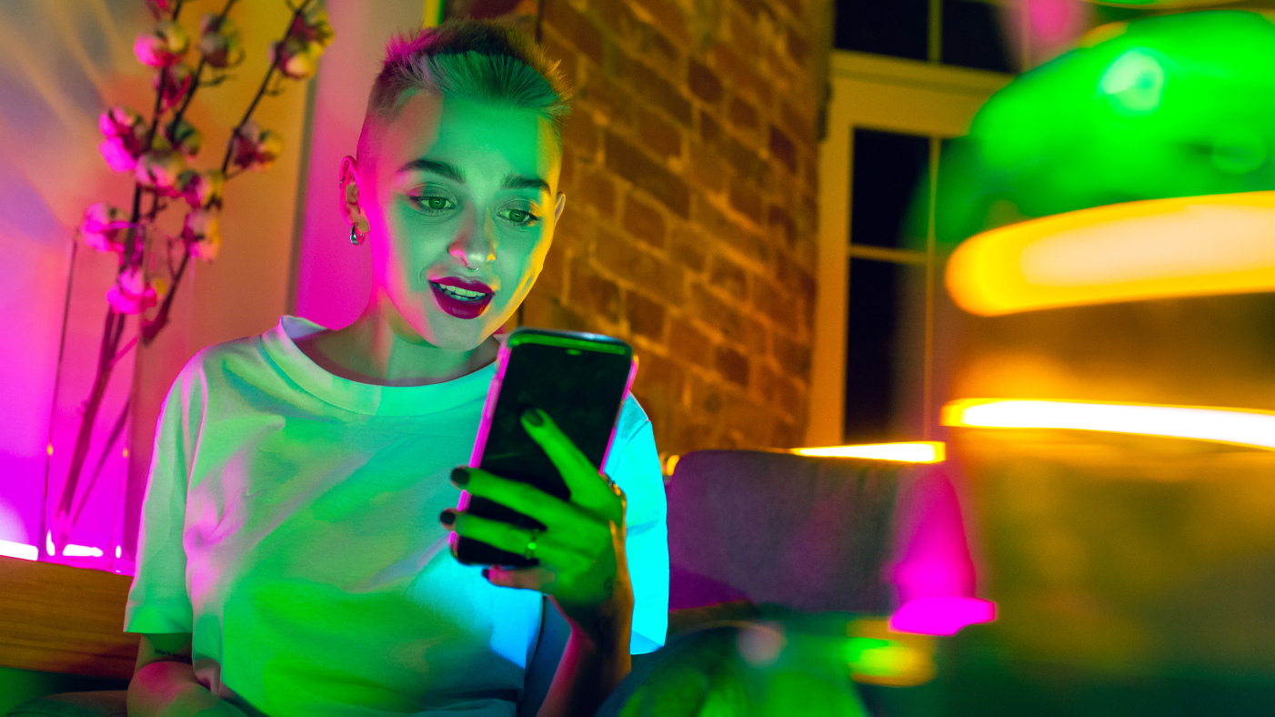 Girl with short hair looking at the mobile phone screen