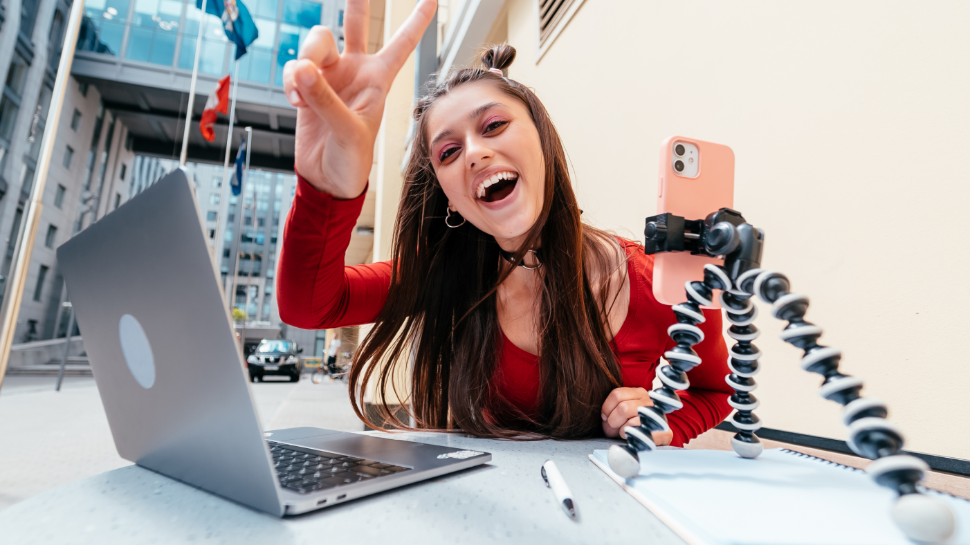 Smiling girl filming social media videos